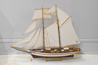 Lot 1552 - A two masted model sailing boat, height 77cm.