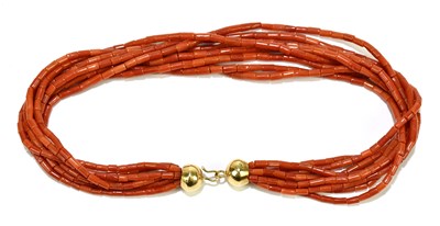 Lot 1335 - A multi strand coral necklace with yellow...