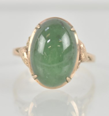 Lot 1339 - A 14k rose gold dress ring with half jade...