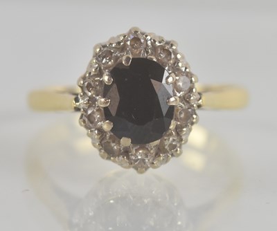 Lot 1313 - An 18ct yellow gold diamond and sapphire ring,...