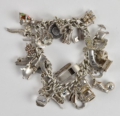 Lot 1485 - A 925 silver charm bracelet including roller...