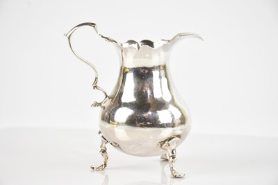 Lot 386 - JOHN MUNS; a George II hallmarked silver cream...