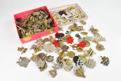 Lot 2345 - A collection of military cap badges, some...