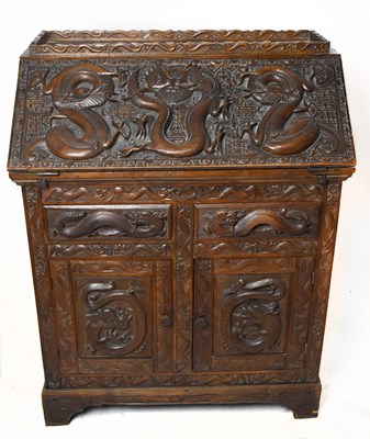Lot 1565 - An Eastern profusely carved hardwood bureau