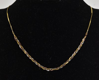 Lot 1419 - A 9ct tricolour gold semi-rigid necklace, with...