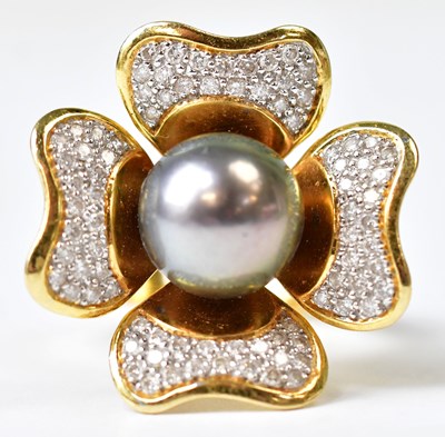Lot 691 - A yellow metal flower ring set with central...