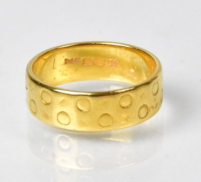 Lot 787 - A 22ct yellow gold wedding band with engraved...