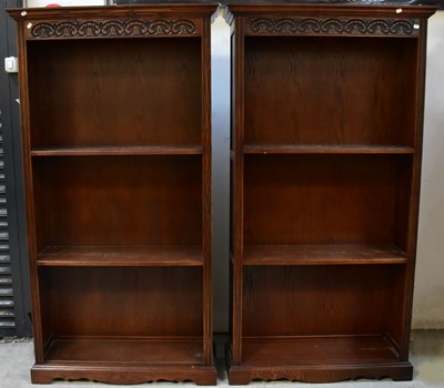 Lot 24 - A pair of Old Charm carved oak floor standing...