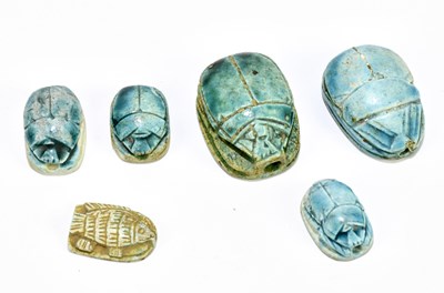 Lot 1549 - Five Egyptian turquoise glazed faience scarabs,...