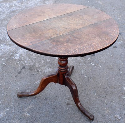 Lot 1702 - A 19th century oak circular tilt-top table