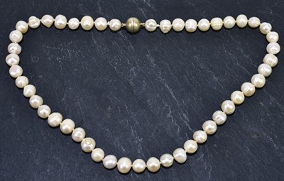 Lot 1337 - A string of hand tied baroque pearls, length...