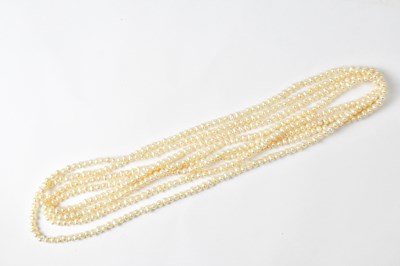 Lot 718 - A long single-strand continuous pearl necklace,...