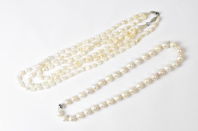 Lot 723 - A three-strand pearl necklace with clear seed...