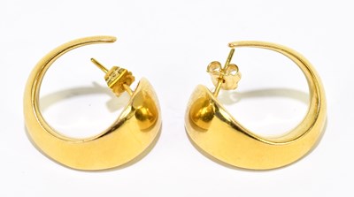 Lot 1489 - A pair of yellow metal swept hoop earrings,...