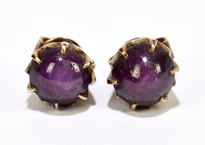 Lot 1499 - A pair of rose gold coloured and star ruby ear...