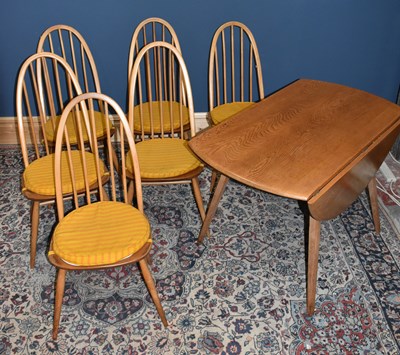 Lot 1458 - ERCOL; a light elm drop-leaf dining table,...