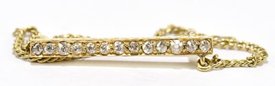 Lot 1462 - A yellow metal and diamond bar brooch set with...
