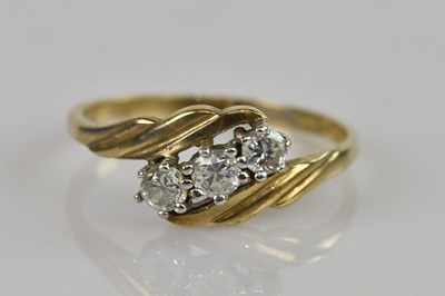 Lot 2513 - A 9ct yellow gold dress ring set with three...