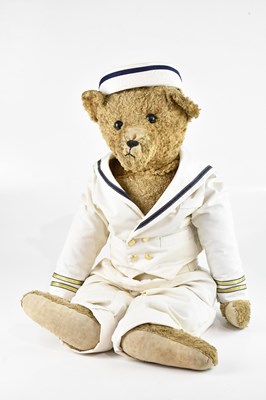 Lot 1590 - A large teddy bear in naval uniform, height 82cm.