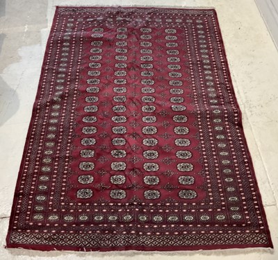 Lot 2165 - A hand knotted wool red ground Bokhara carpet,...