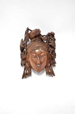 Lot 135 - A Chinese carved hardwood mask of a female...