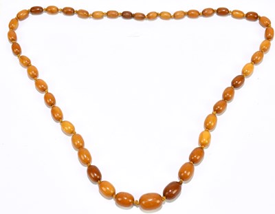 Lot 1398 - A single strand of butterscotch amber coloured...