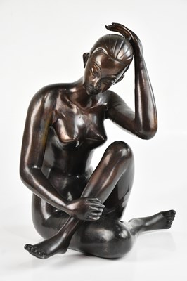 Lot 2402 - A reproduction bronze nude seated female,...