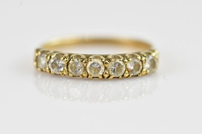Lot 2375 - A yellow metal half eternity dress ring, set...