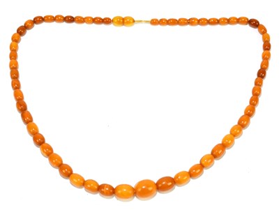 Lot 1399 - A strand of butterscotch amber style beads,...