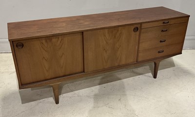 Lot 2096 - A mid century teak sideboard with two sliding...
