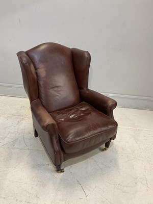 Lot 86 - A modern leather wingback arm chair.