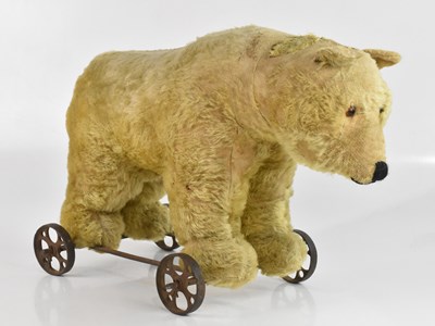 Lot 1591 - A roll-along stuffed polar bear, height 37cm.