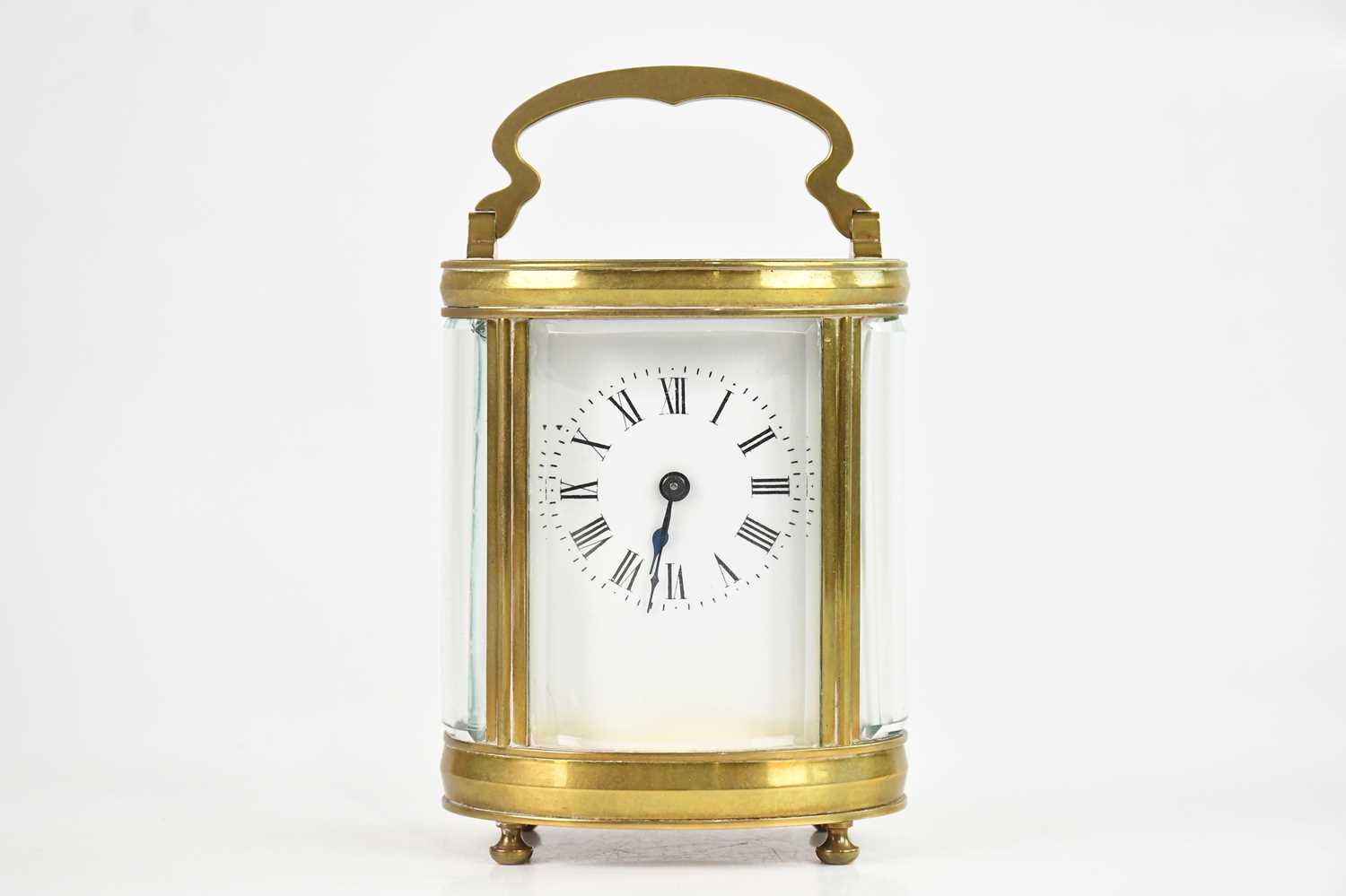 Lot 2185 - A French brass cased oval carriage clock, with...
