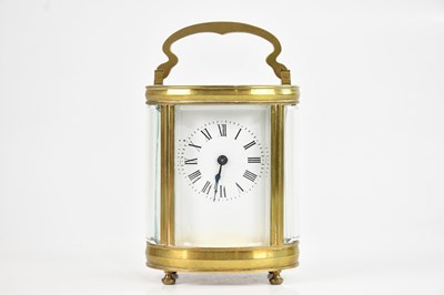Lot 2185 - A French brass cased oval carriage clock, with...