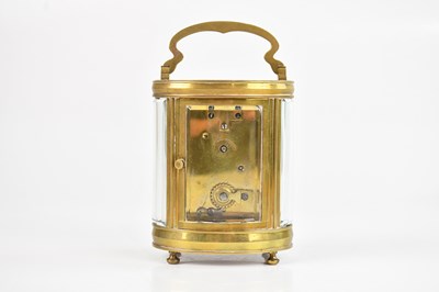 Lot 2185 - A French brass cased oval carriage clock, with...