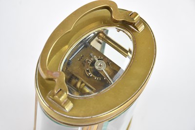 Lot 2185 - A French brass cased oval carriage clock, with...