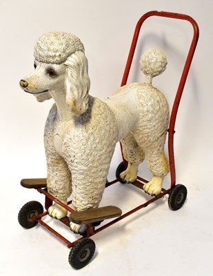 Lot 359 - TRI-ANG; a metal push-along poodle on wheeled...