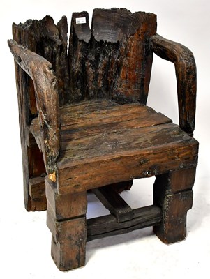 Lot 22 - A bog oak open armchair with arched back and...