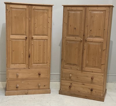 Lot 63 - A pair of modern pine wardrobes, each with two...