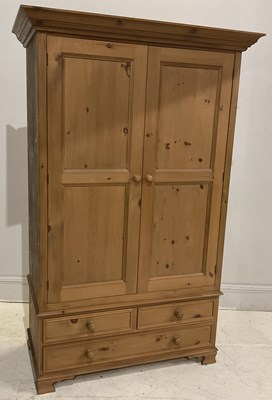 Lot 64 - A modern pine two door wardrobe, with three...