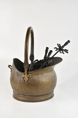 Lot 2319 - A brass coal scuttle and a companion set, (2).
