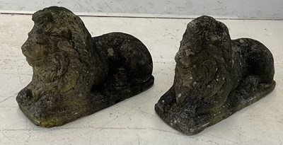 Lot 2154 - A pair of reconstituted stone recumbent garden...
