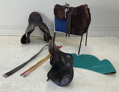 Lot 273 - Two leather saddles, with a saddle stand and...