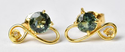Lot 937 - A pair of yellow metal stud earrings, each set...