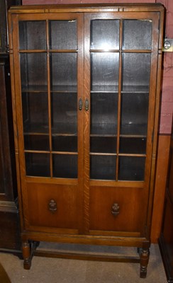 Lot 1663 - An early 20th century oak display cabinet