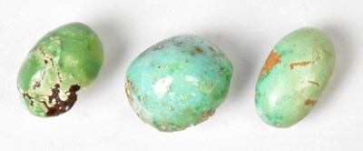 Lot 1033 - Three unmounted cabochon cut turquoise stones,...
