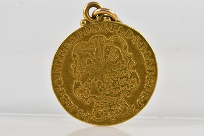 Lot 1020 - A George III shield back full guinea, 1748.