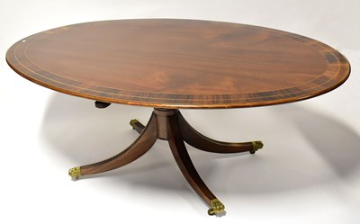 Lot 30 - A Regency-style inlaid mahogany oval dining...