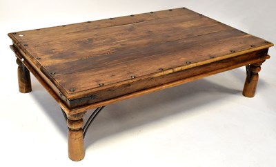 Lot 45 - An Eastern rustic coffee table with plank top...