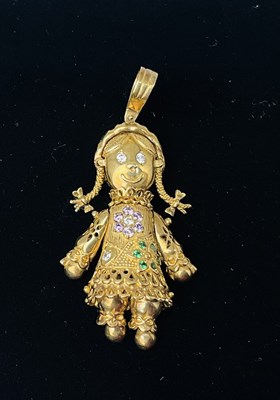 Lot 653 - A yellow metal gem set figural charm, with...